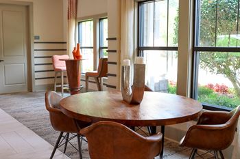 A dining room with a table and chairs